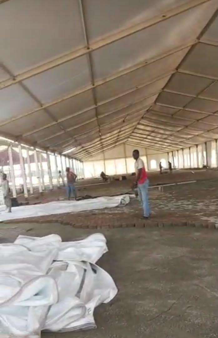 Interior of a large marquee under construction showing steel framework